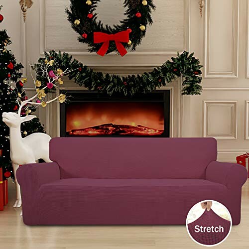 Christmas-themed living room with red sofa and fireplace.