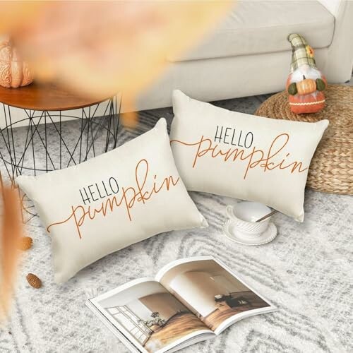 Two pillows with 'Hello Pumpkin' text on a cozy living room floor