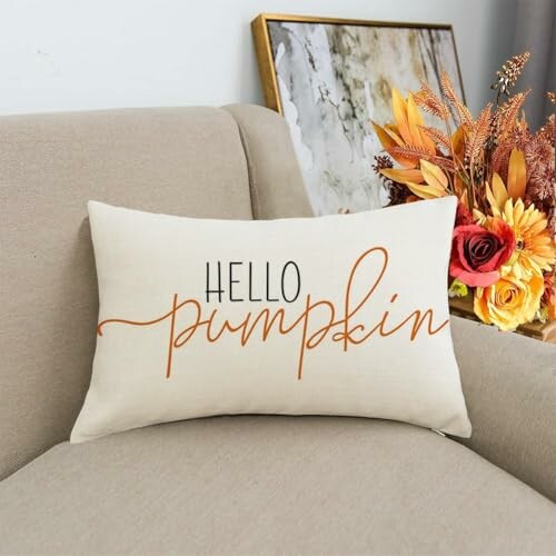 Beige pillow with 'Hello Pumpkin' text on a couch